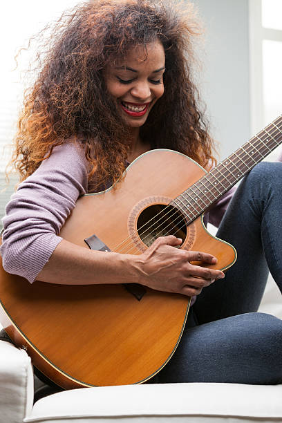 istock woman having fun with her guitar 624751730