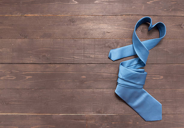 istock Blue necktie is on the wooden background 624752272