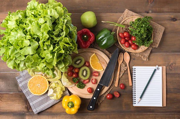 istock vegetables and fruit with notebook on wood background 624753264