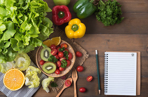 istock vegetables and fruit with notebook on wood background 624753332