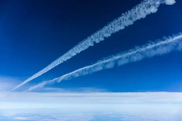 mid air view of jet contrails in the sky