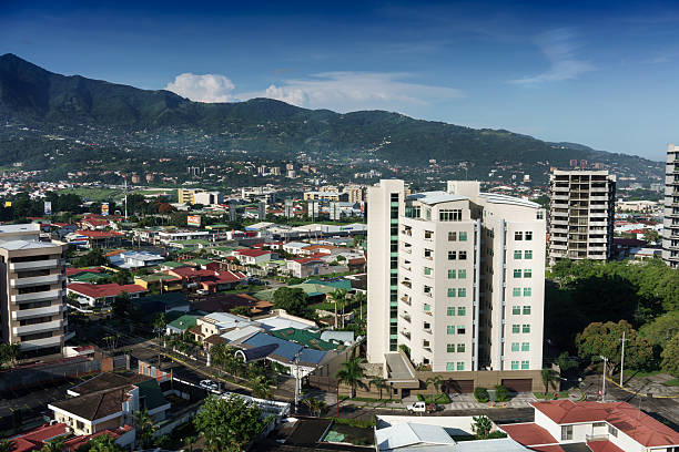 istock Elevated view of cityscape with mountain range in background, Co 624771100