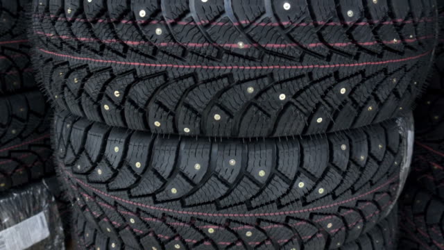 Car winter tires with spikes. Studded tires close up.