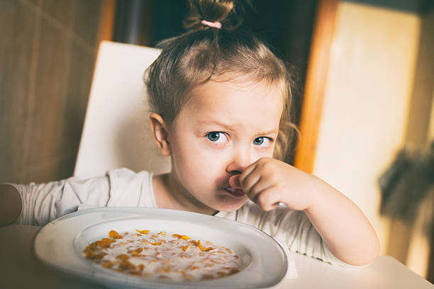 istock Little girl eating corn flakes 624848876