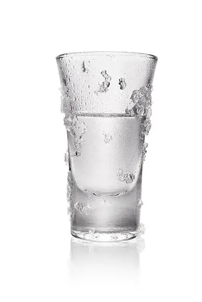 Glass of vodka with ice crystals isolated on white background with clipping path