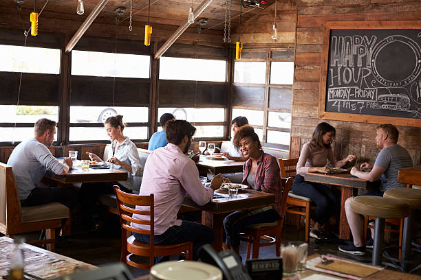 istock Couples enjoying lunch at a busy restaurant 624851534