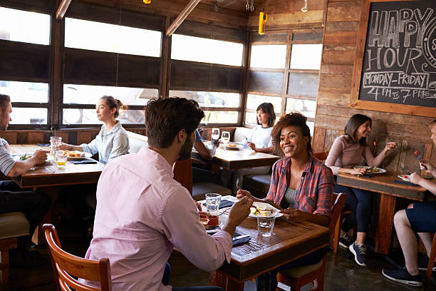 istock Mixed race couple enjoying lunch in a busy restaurant 624851568