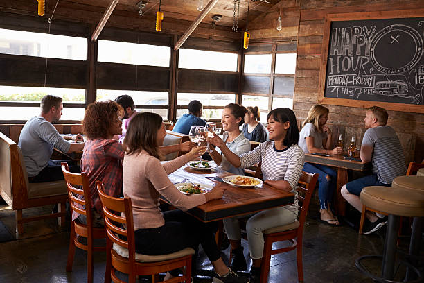 Female friends making a toast during lunch at a restaurant