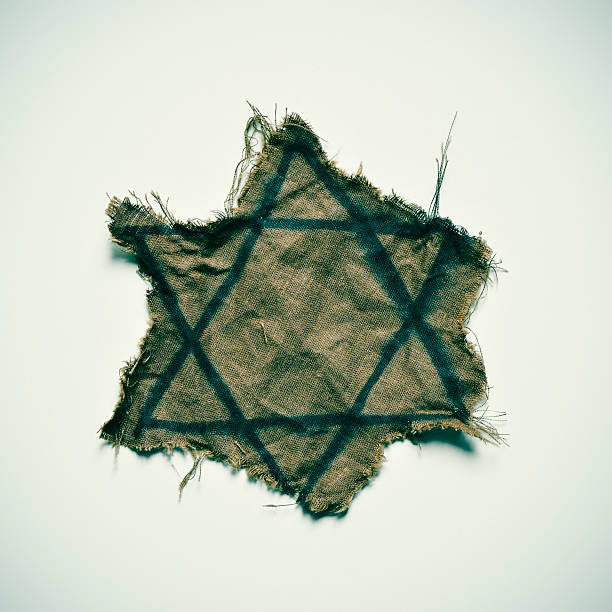 closeup of a ragged Jewish badge on an off-white background