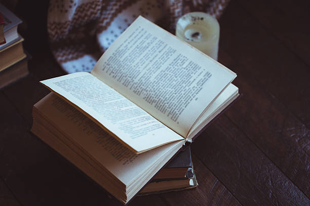 istock Stack of books with warm plaid on chair 624854578