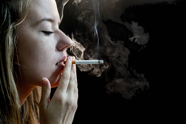 istock Elegant brunette Woman Smoking a dangerous Cigarette 624867072