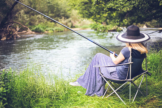 istock woman fishing in river 624867966