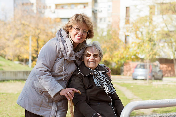 istock Happiness senior woman with female assistant 624868740