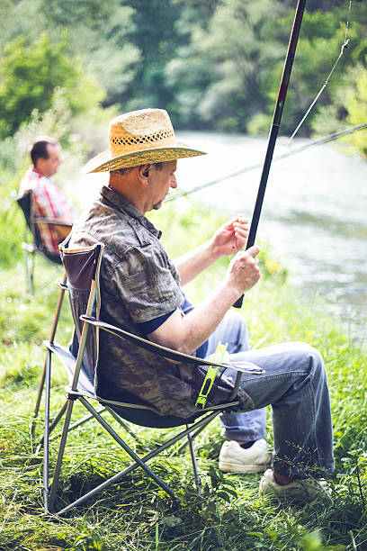 istock people fishing on the river 624869424