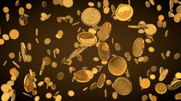 istock golden dollar coins with depth of field effect. 624869544