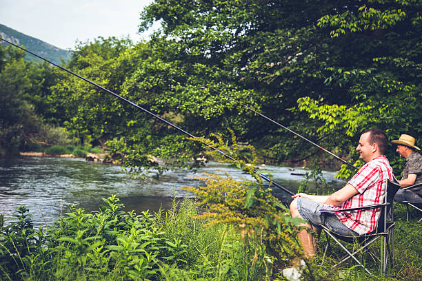 istock people fishing on the river 624872272