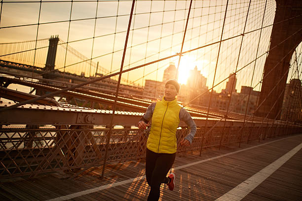 istock Female athlete jogging on the bridge 624873158