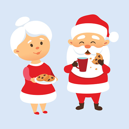 Santa Claus eating a cookies and drinking milk with his wife. Mrs. Santa Claus treat and feed Mr. Santa Clause cookies. Christmas tradition. Cute Santa Claus family couple. Mother and Father Christmas