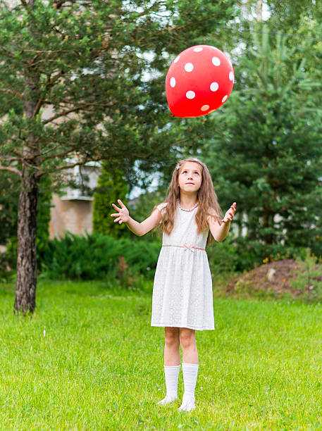 istock Girl and her red balloon 624873736