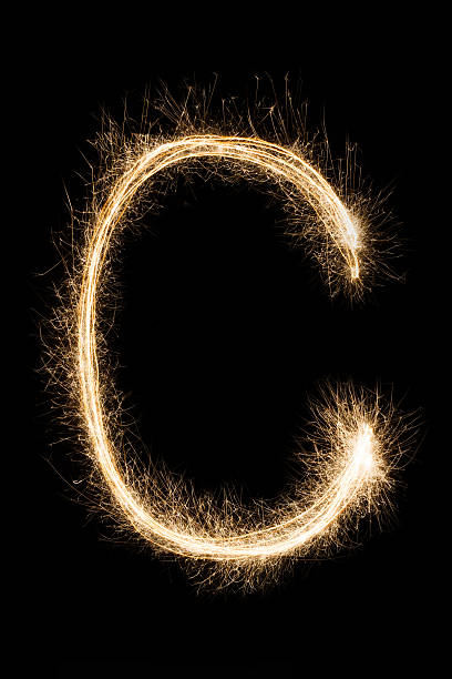 istock English Letter C from sparklers alphabet on black background. 624873946