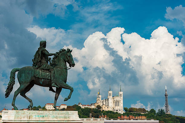 Statue of Louis XIV on Place Bellecour built in 1826 from François-Frédéric Lemotand. In background basilica in Lyon.