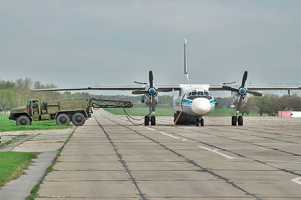 Ukrainian Air Force An-26 Vasilkov, Ukraine - April 24, 2012: Ukraine Air Force Antonov An-26 cargo plane is preparing to start the engines with the starter vehicle antonov an 26 stock pictures, royalty-free photos & images