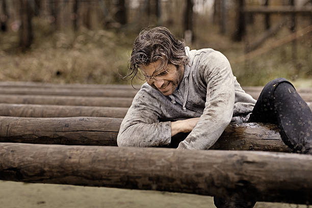 istock Caucasian brunette handsome man crawling over obstacle during mud run 624875462