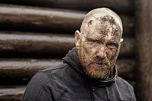 Caucasian bearded shaved redhead adult man posing during mud run