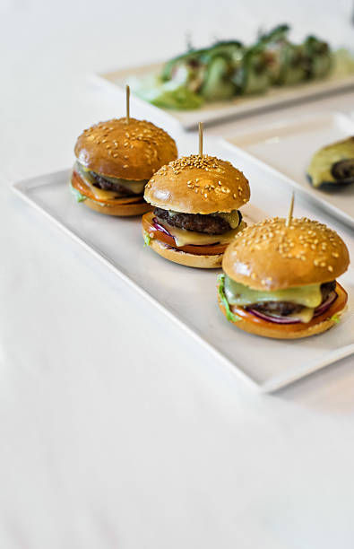istock burgers on a white table 624878798