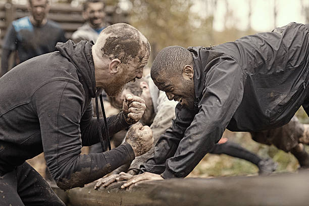 istock Caucasian man personal trainer coaching mud run team of men 624878826