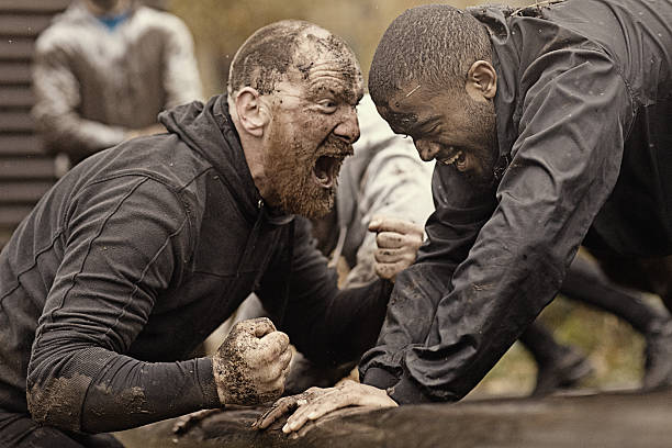 istock Caucasian man personal trainer coaching mud run team of men 624879096
