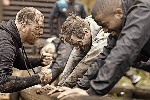 istock Caucasian man personal trainer coaching mud run team of men 624879102