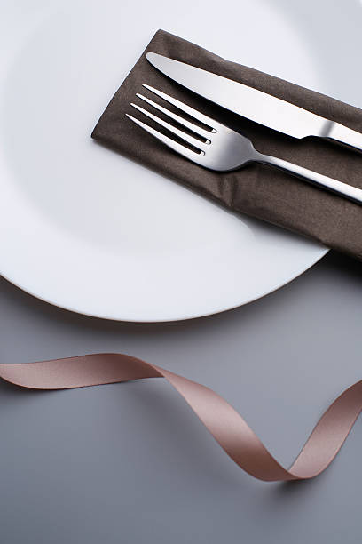 istock Special dinner set. Fork,  Knife and nappkin ribbon flower shape 624879174