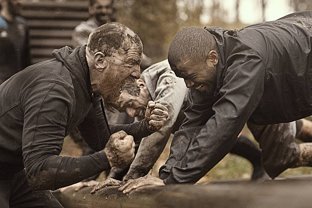 istock Caucasian man personal trainer coaching mud run team of men 624879294