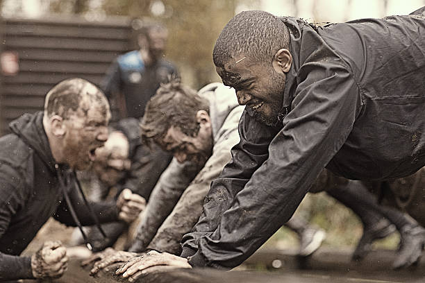 istock Caucasian man personal trainer coaching mud run team of men 624879386
