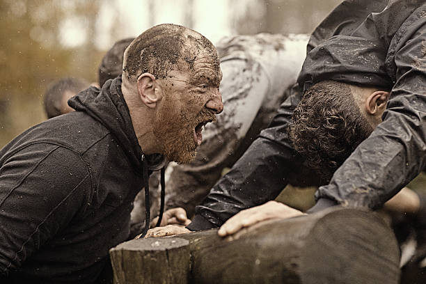 istock Caucasian man personal trainer coaching mud run team of men 624879678