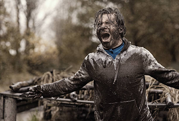 istock Caucasian brunette handsome man at obstacle during a mud run 624880204