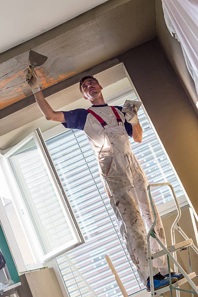 istock Plasterer renovating indoor walls and ceilings. Finishing works. 624886258