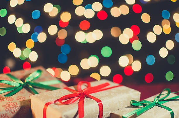 istock Christmas card. Holiday gift boxes on the bright blurred 624886560