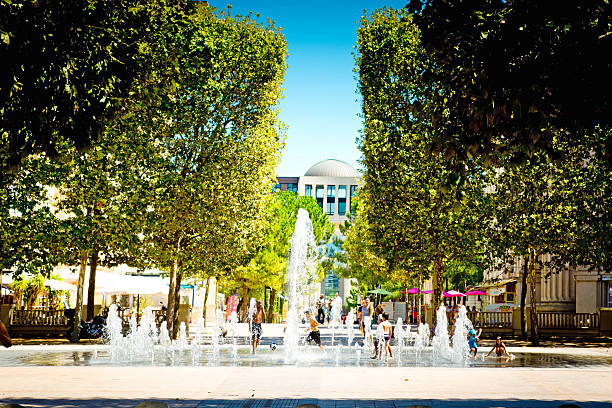 Montpellier, France - August 5, 2015: Cityscape of Montpellier France showing the modern shopping area of Lafayette and the fountain in the foreground.