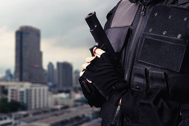 istock man hold gun in city 624888780