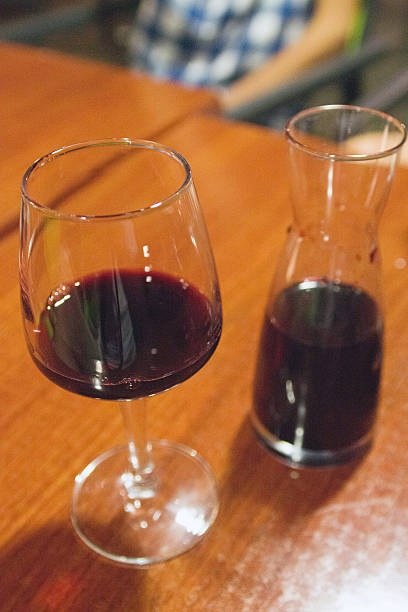 istock Red wine glass and carafe on a table 624890428