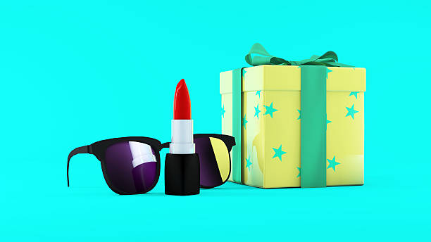 Red lipstick, sunglasses and giftbox on mint background. Beauty concept.
