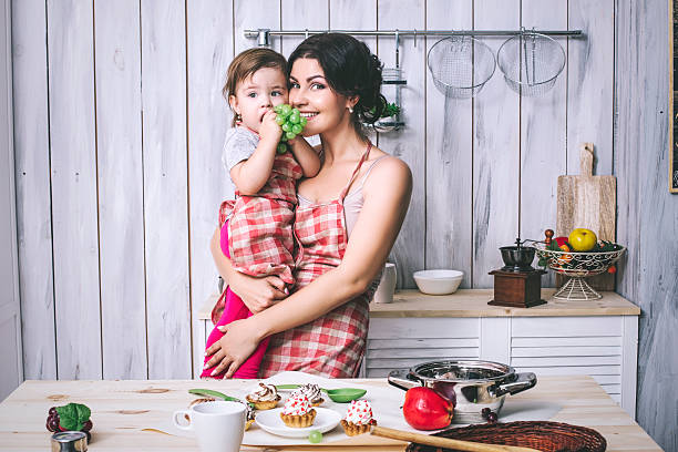 istock Mother and small child in the kitchen at home beautiful 624893980