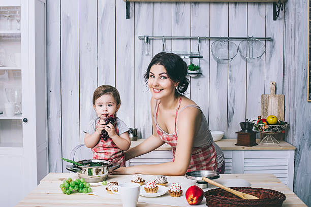 istock Mother and small child in the kitchen at home beautiful 624894510