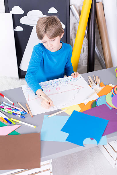 istock Boy painting something on a paper 624896738