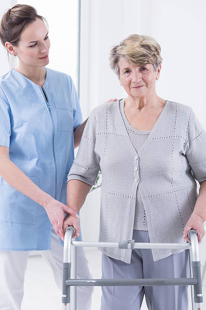 istock Woman walking with the walking frame 624897736