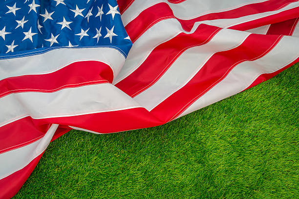 istock American flag on green grass 624897986