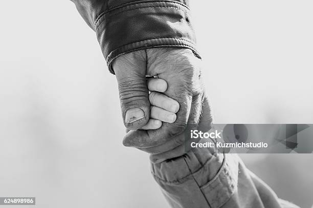 Baby Girl Warm Jacket And Cap C Grandfather Hands In Stock Photo - Download Image Now