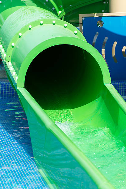 istock Green water slide in waterpark resort. 624905442